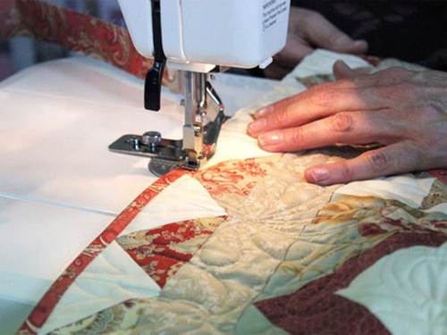 A close-up of a person sewing a quilt

AI-generated content may be incorrect.